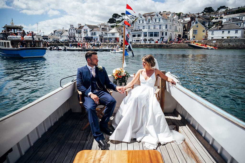 bride and groom on boat on they way to Place Manor