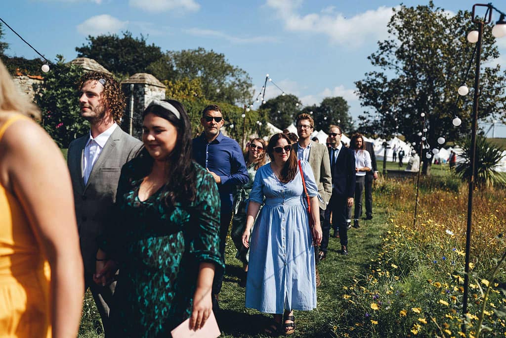 Guests walking into festival wedding in Devon
