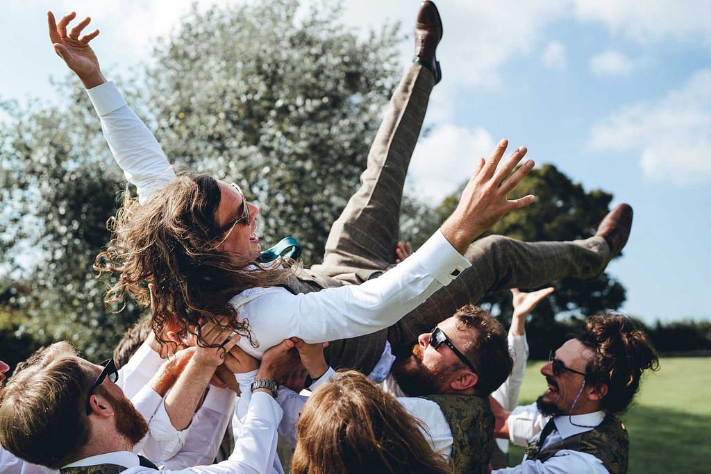 groom in the air at wedding